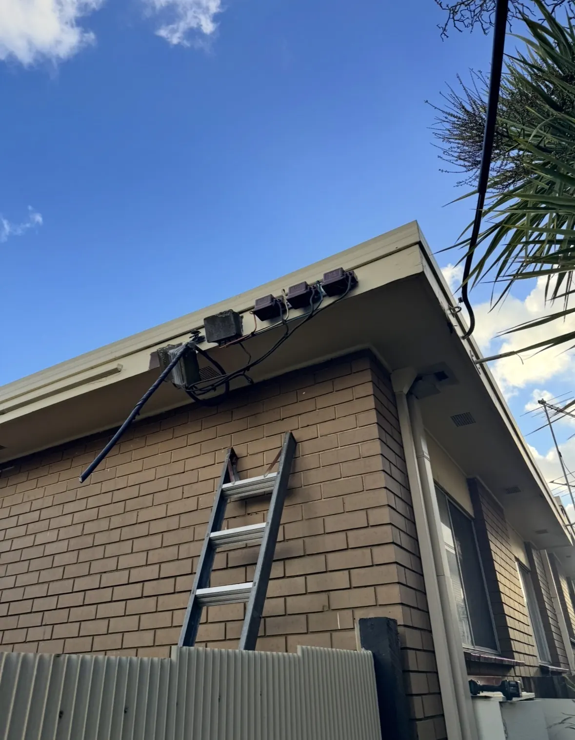 Exterior security lighting installed under the eave