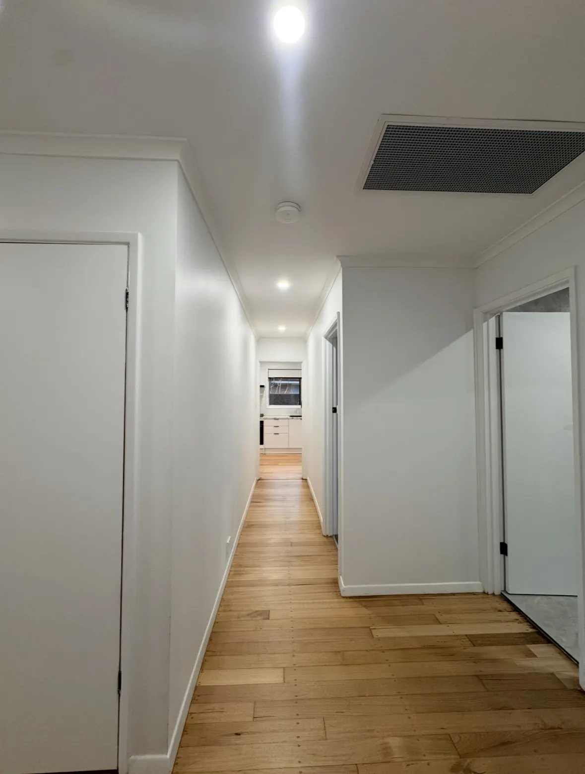 Thomastown house renovation: hallway with new LED downlights and a smoke alarm